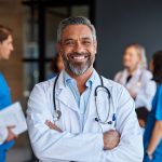Portrait of smiling mixed race doctor in hospital