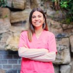 Proud nurse smiling at camera and crossing the arms